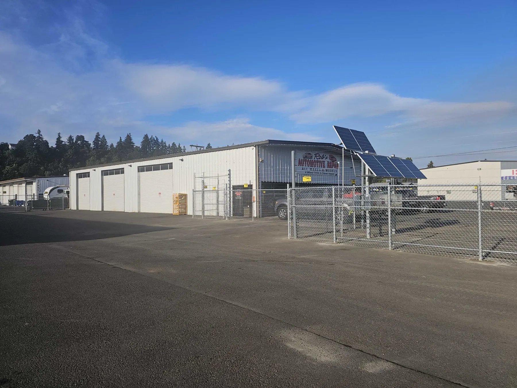 Rob's Automotive Repair Center shop on SE Hwy 212 in Clackamas, Oregon — multi-bay facility with rooftop solar